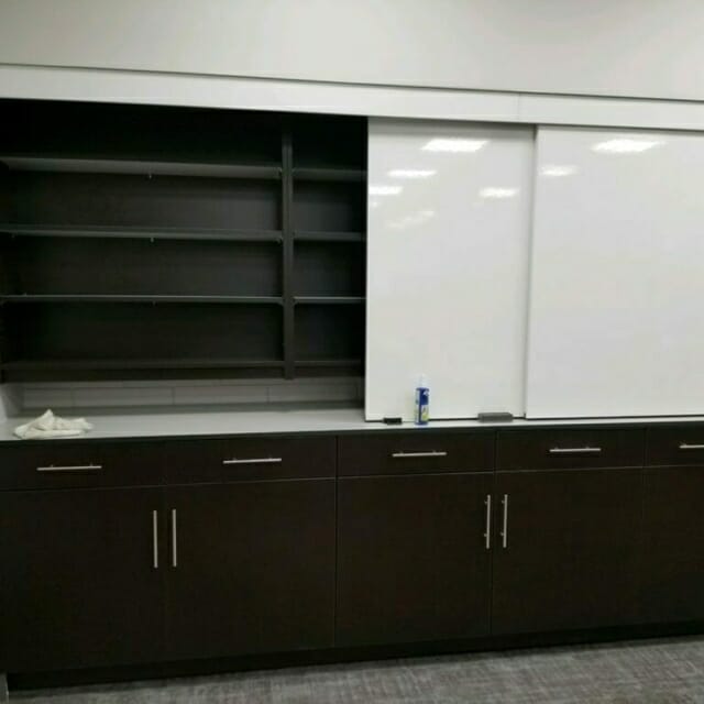 Sliding Whiteboards in front of Casework Storage Wall Sliding Whiteboards in front of Casework Storage Wall