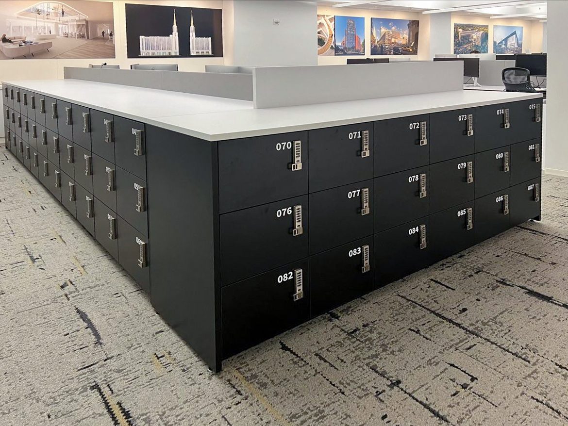 Charcoal locker island with digital locks in open-plan NYC office