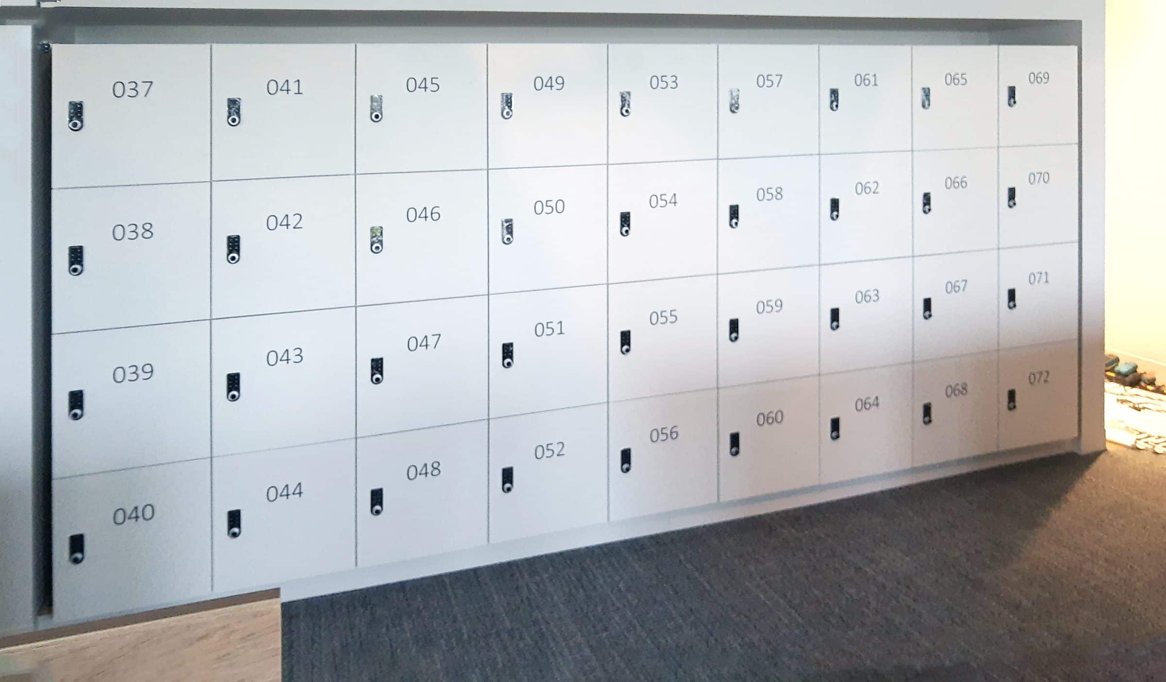 Enterprise gray numbered locker wall bank in open office