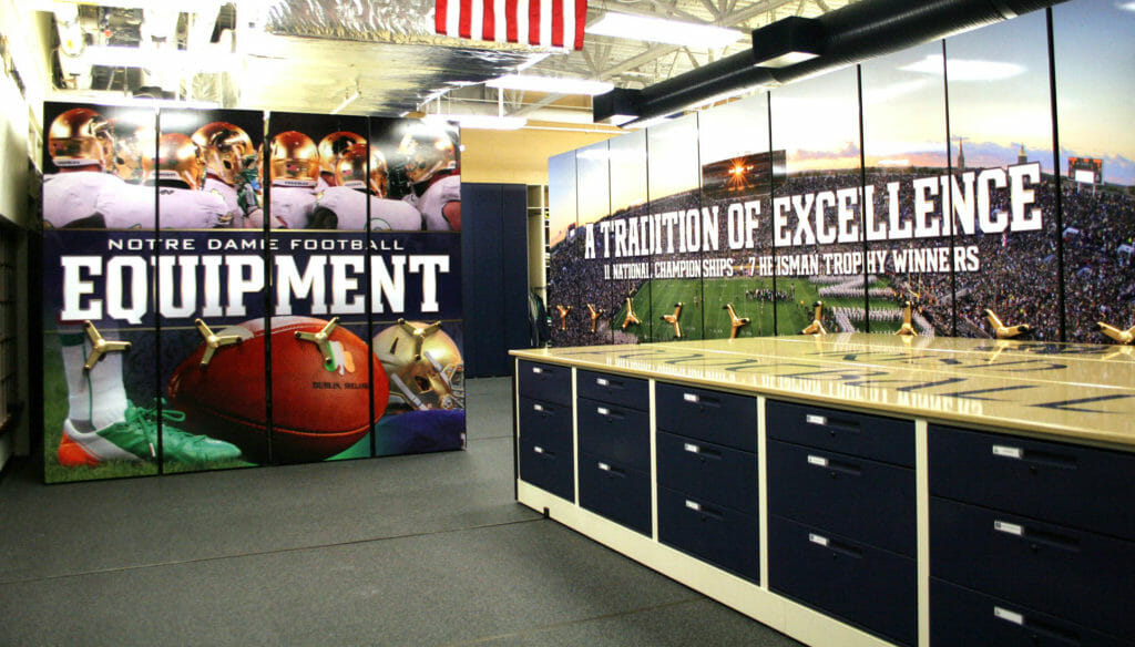 Storage in Plain Sight at Notre Dame's Football Equipment Storage Room - Custom Mobile Shelving with End-Panel and Counter-Height Worksurface
