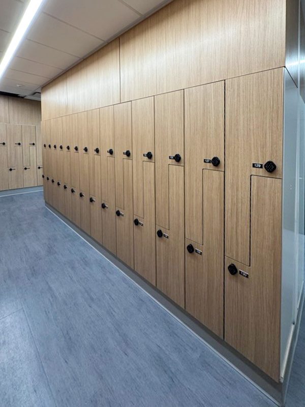 Oak woodgrain lockers in corridor at NYP 66 Hudson Yards NYC