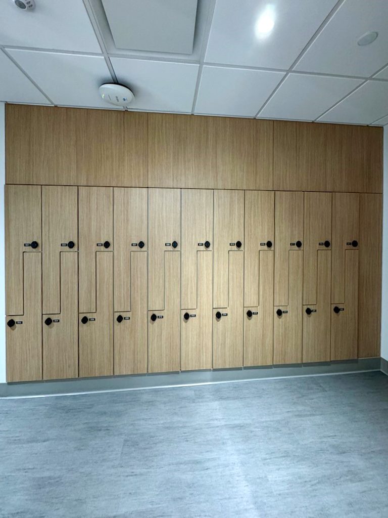 Oak woodgrain full-height lockers — New York-Presbyterian 66 Hudson Yards NYC