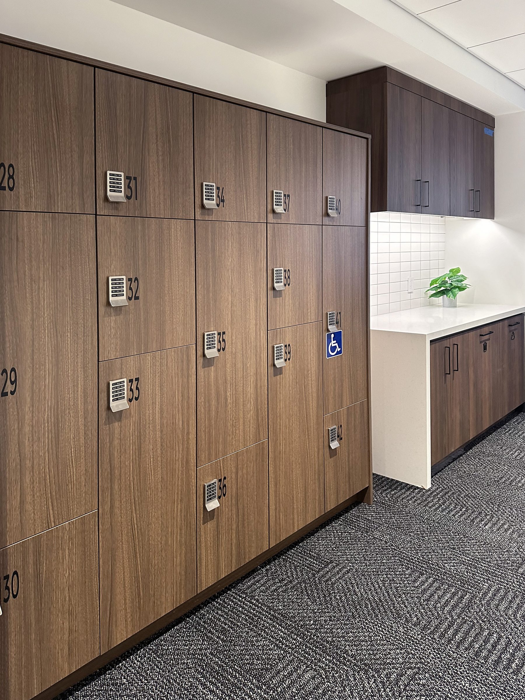 Walnut laminate wall lockers with PIN pad and ADA accessibility