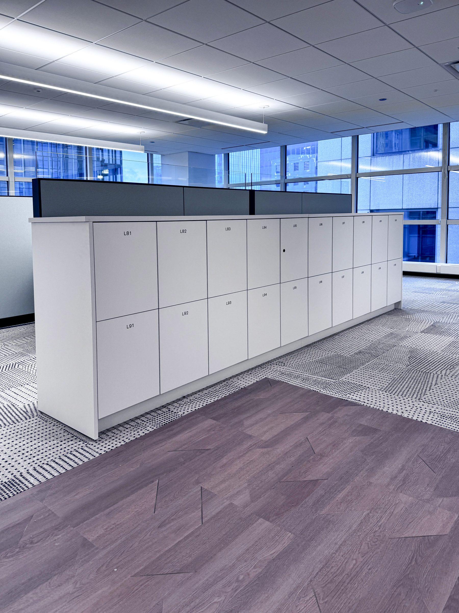 White 2-tier locker bank in high-rise corporate office with city view