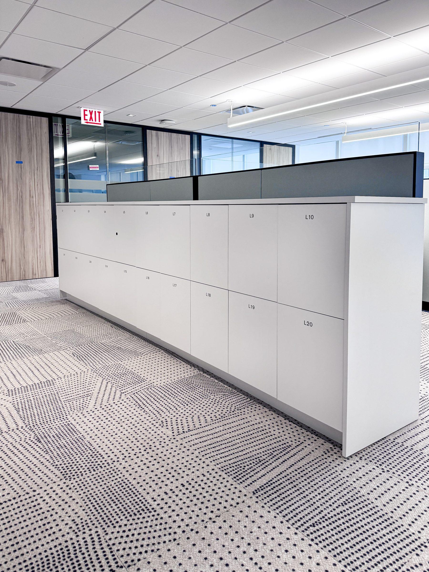 White 2-tier numbered locker bank in a corporate open-plan NYC office