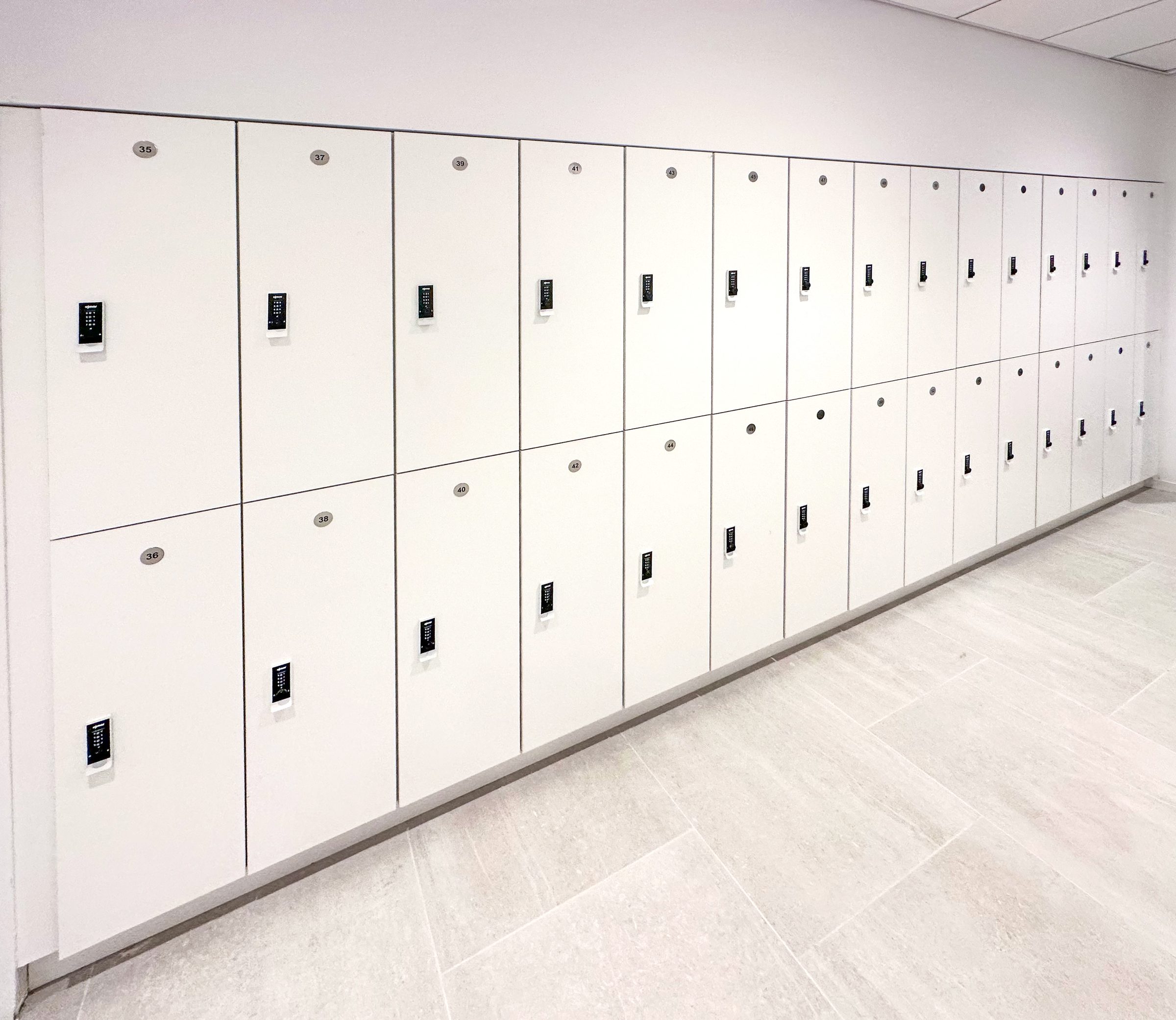 White 2-tier wall lockers with PIN pad — NYC law firm