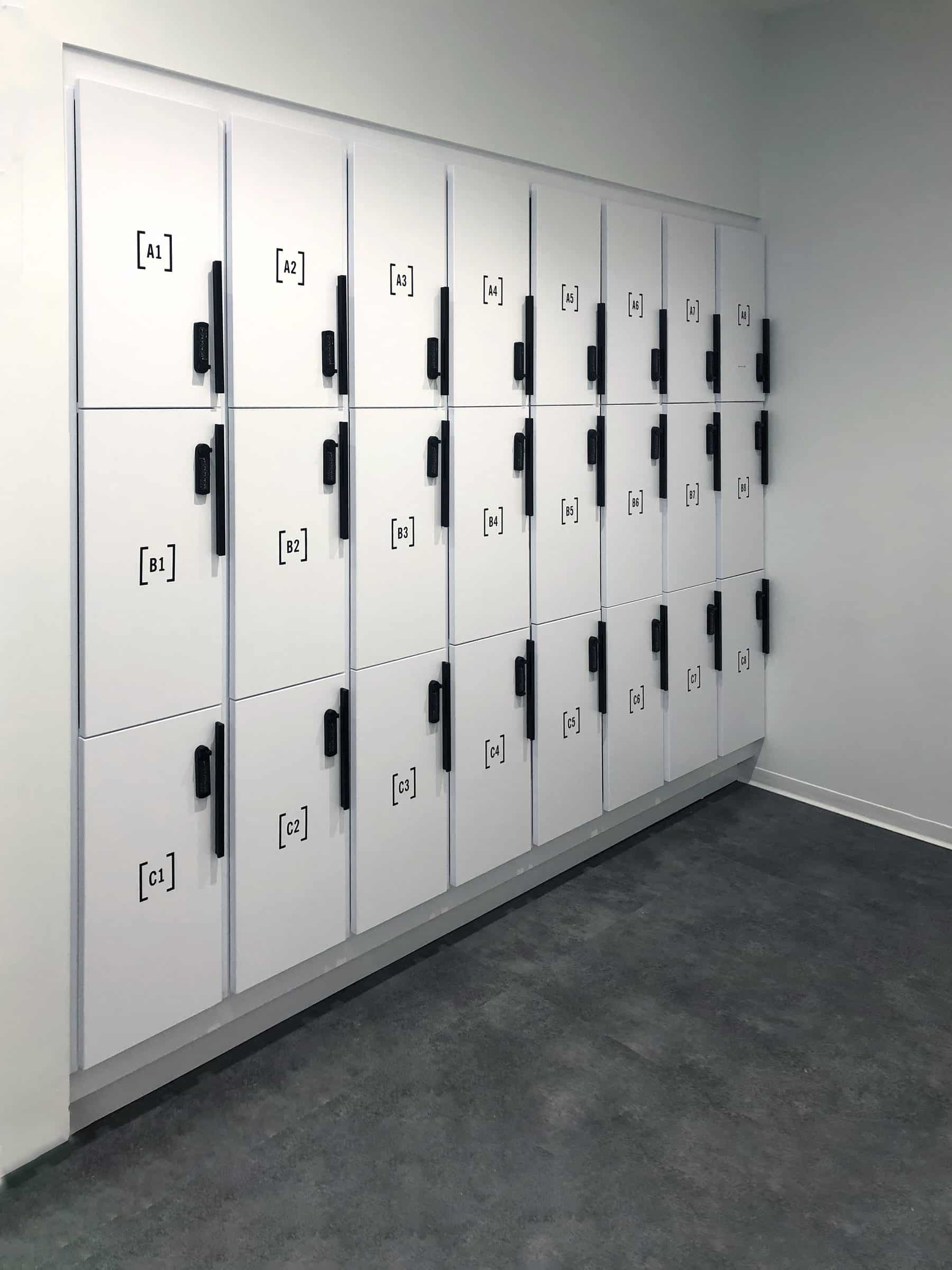 White 3-tier office locker wall — angled view showing depth of installation