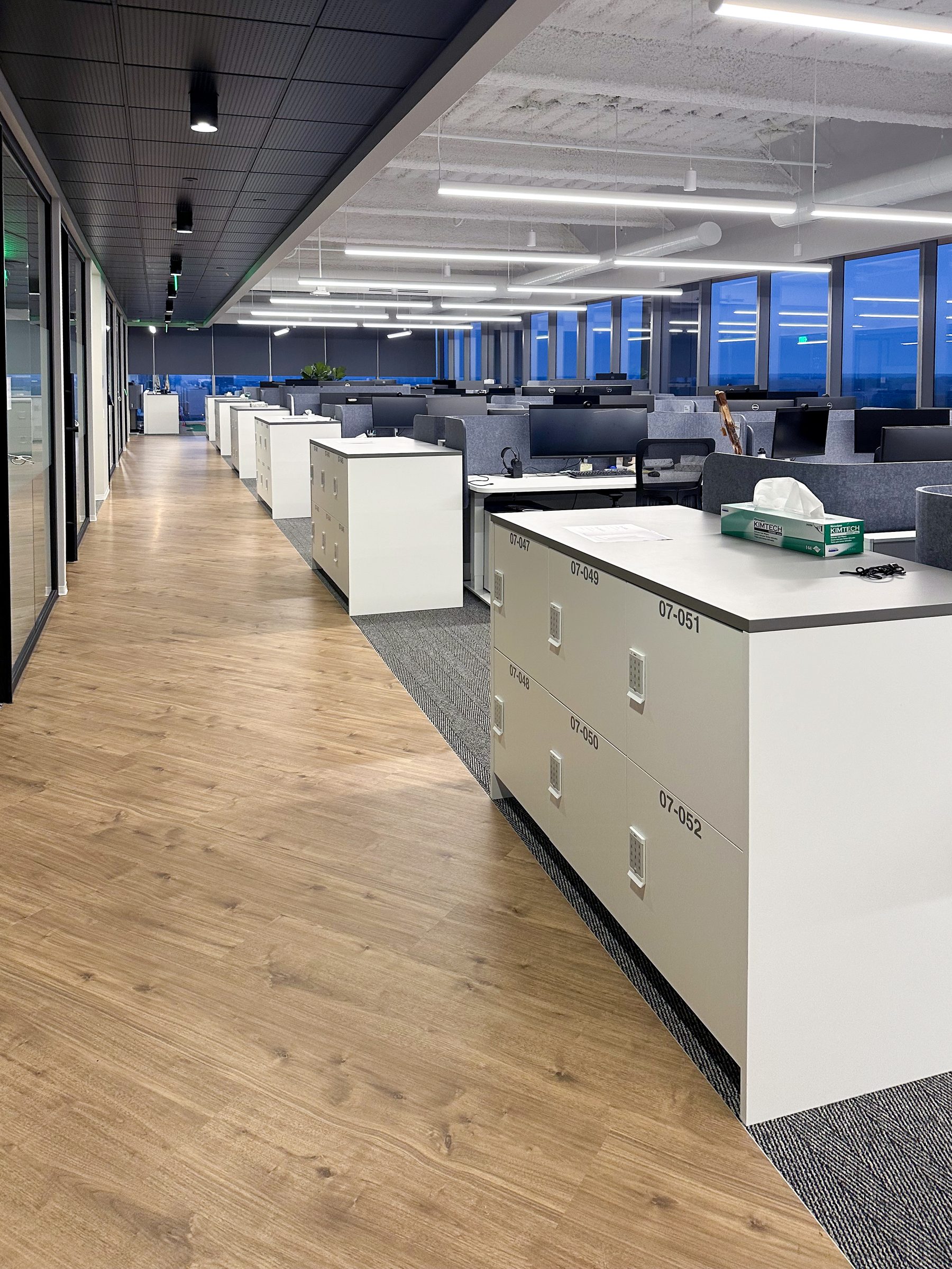 White end-cap locker islands in open-plan office