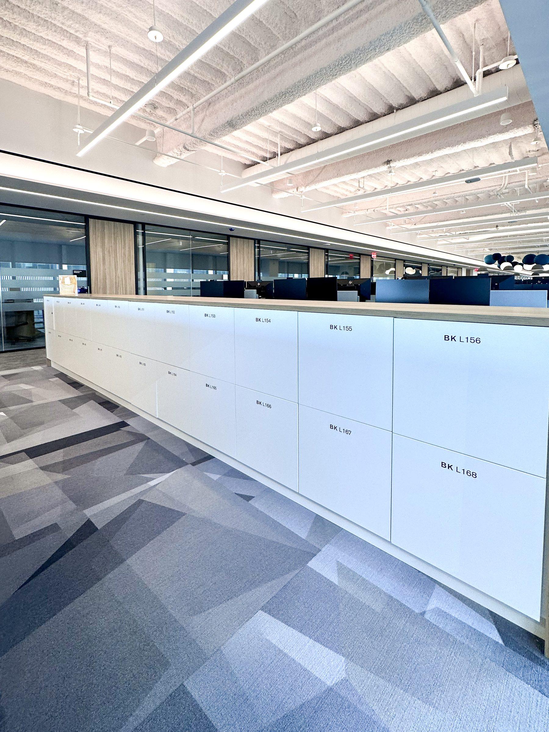 White numbered counter-height lockers in a long enterprise run
