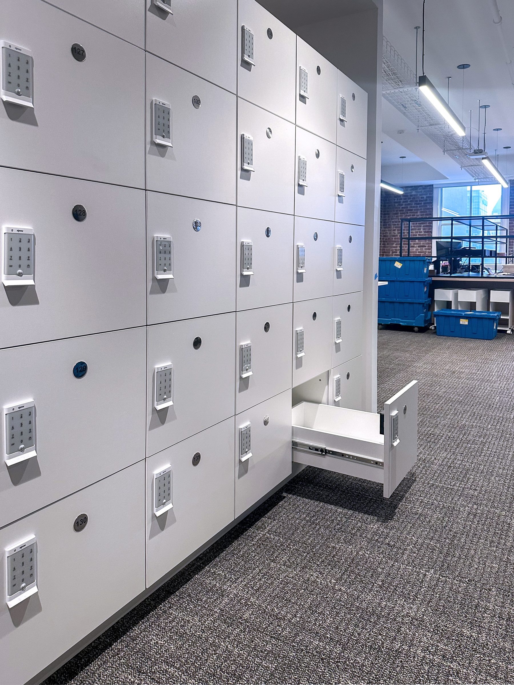 White office locker wall with open drawer — Manhattan corporate installation